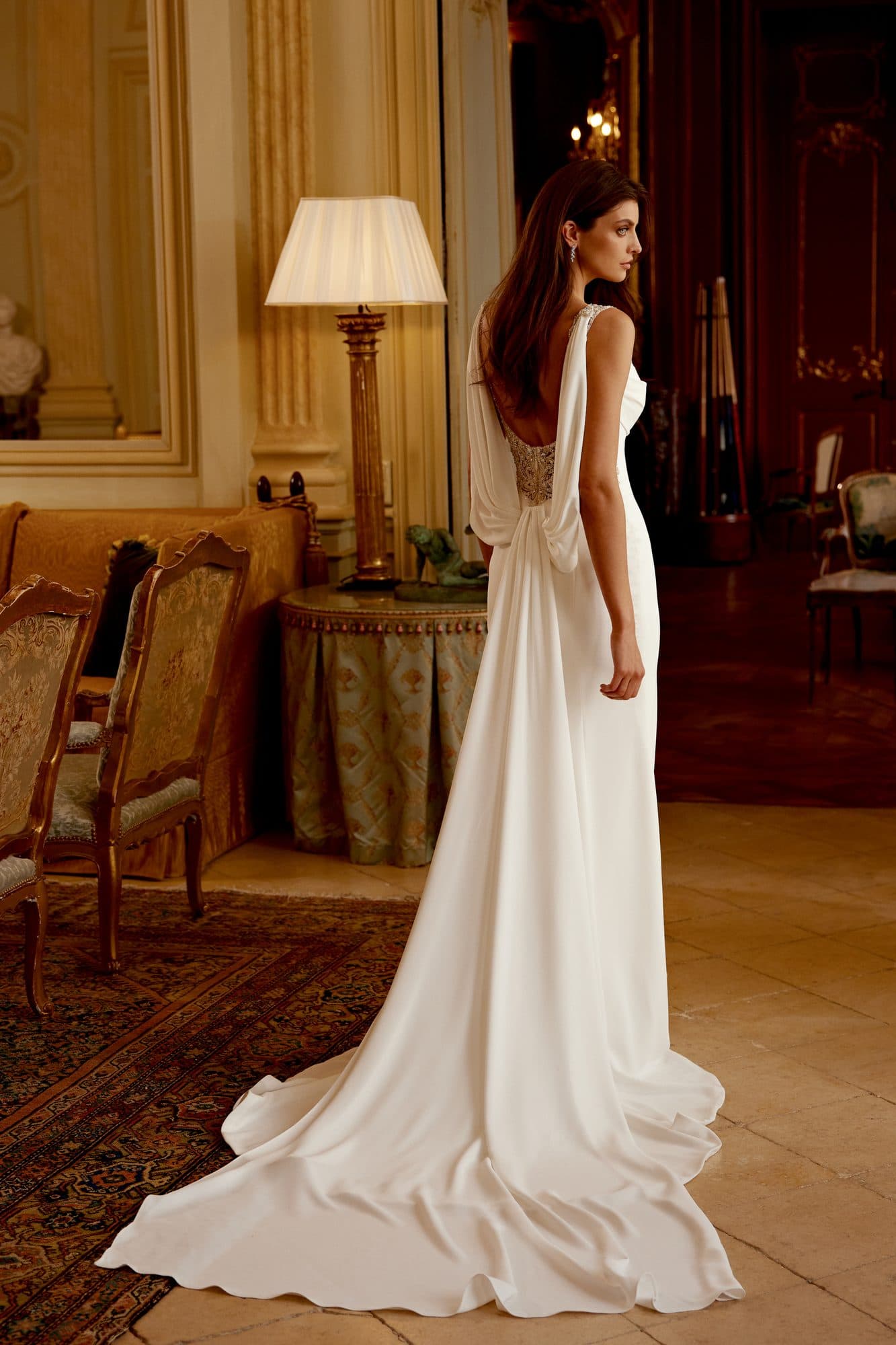 Back of the Justin Alexander Hunter gown showing its draped cowl and beaded detail.