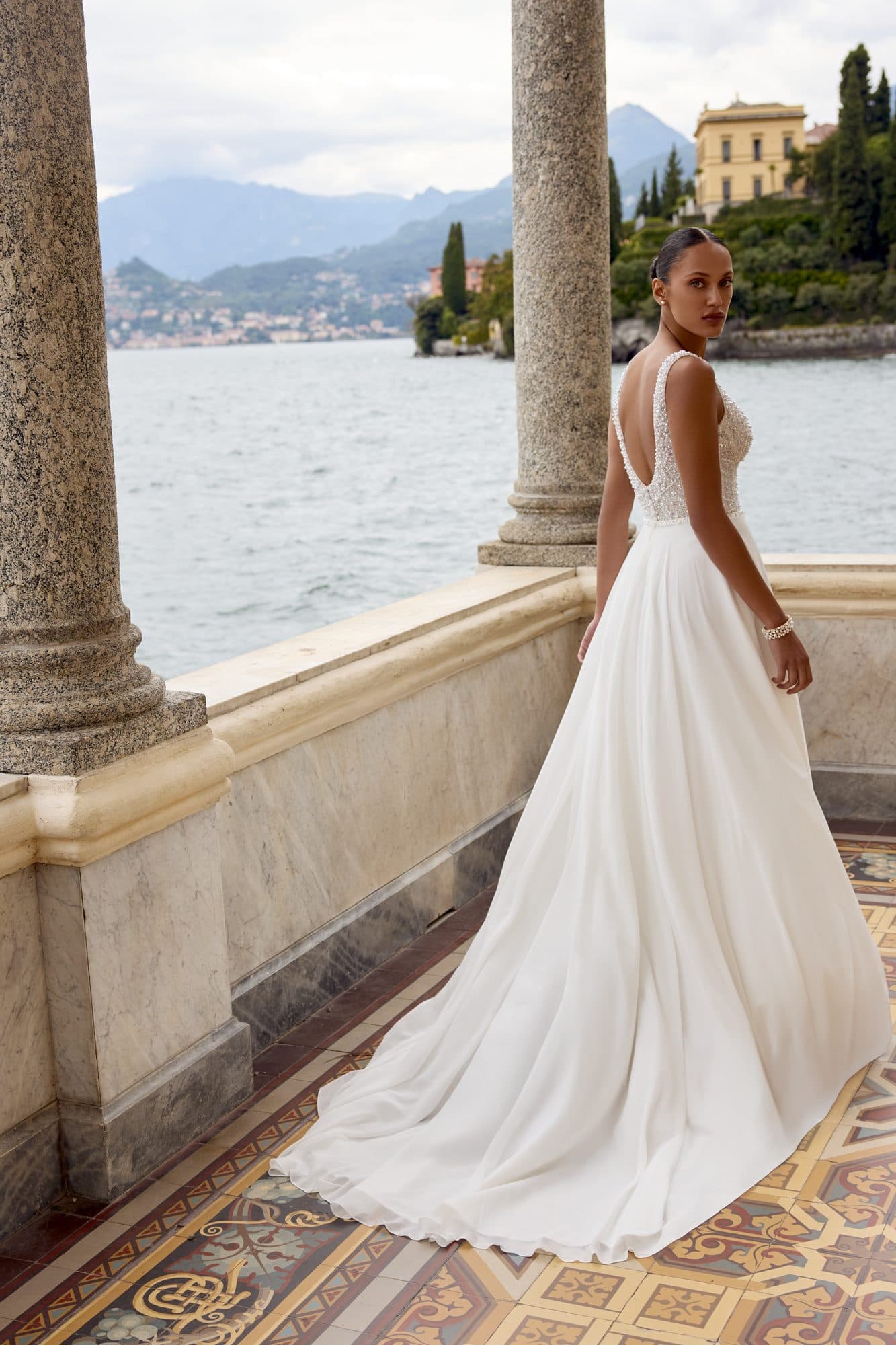 Back of the Justin Alexander Kali gown showing its low beaded back and flowing skirt.