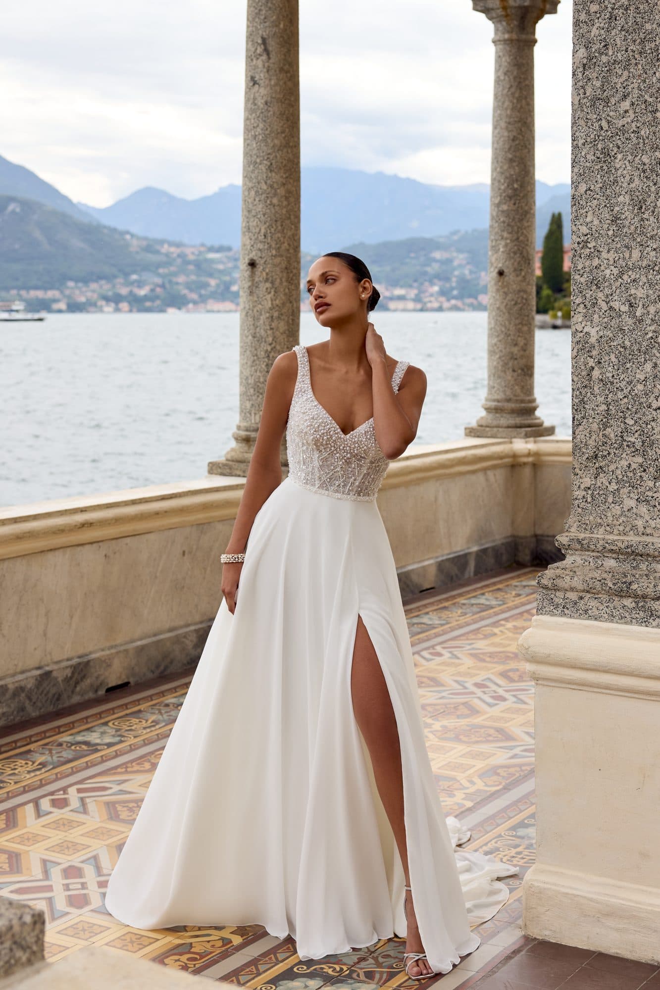 Front of the Justin Alexander Kali gown, a beaded bodice with fine straps and a soft A-line skirt with a slit.