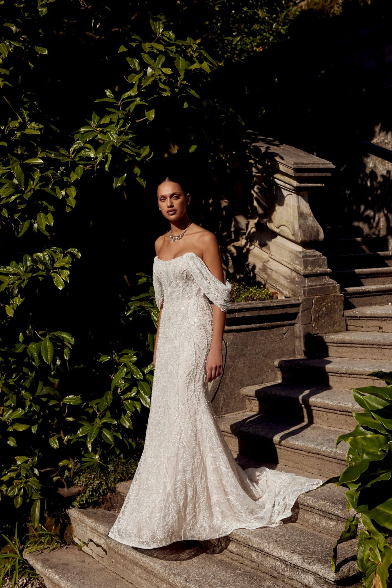 Front of the Justin Alexander Krista gown, a fully beaded fit-and-flare with draped off-the-shoulder sleeves.