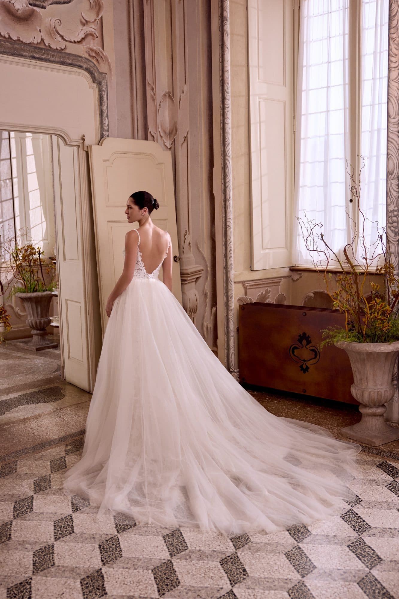 Back of the Justin Alexander Liza gown showing its V-back and long tulle train.