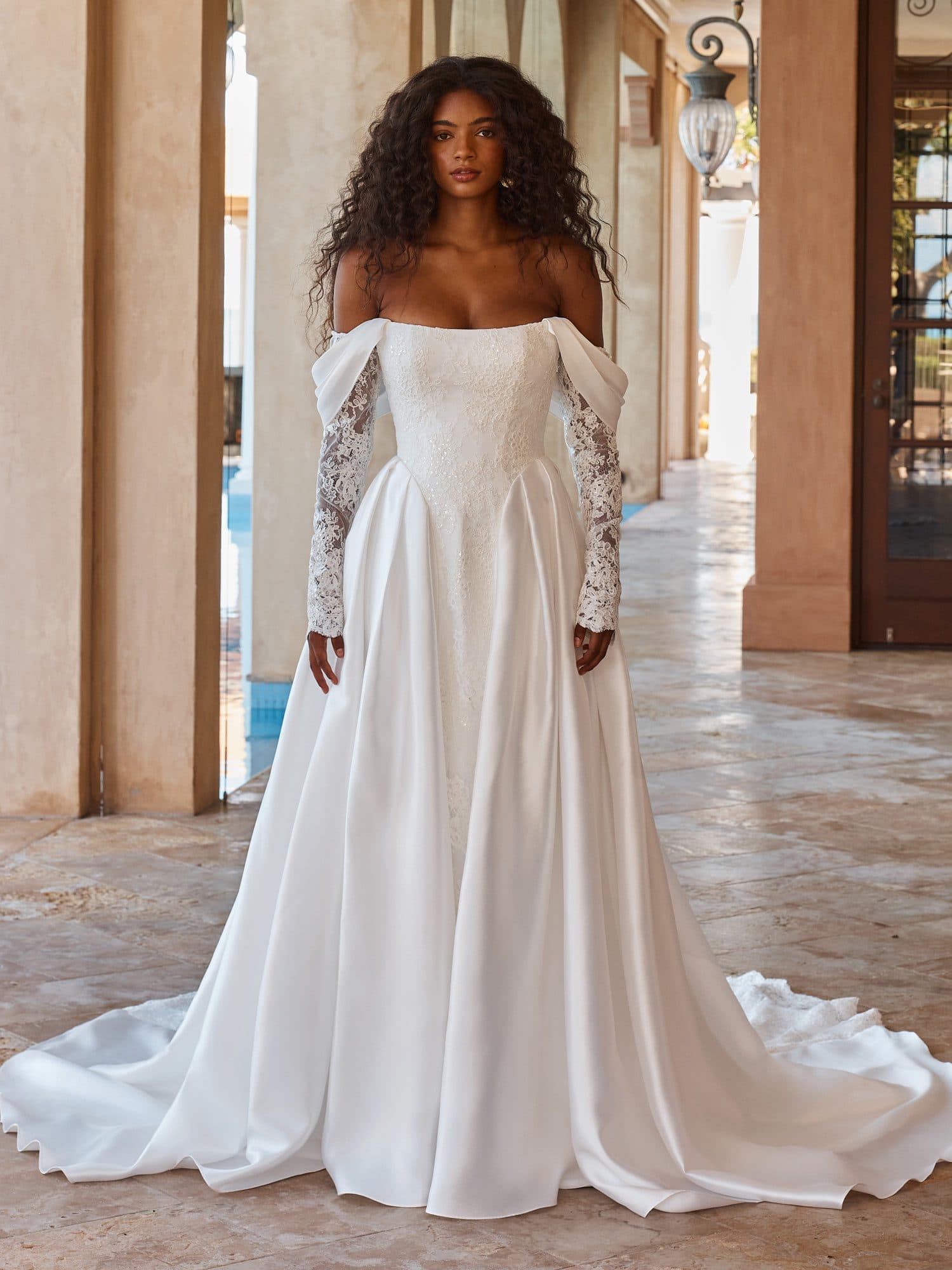 Front of the Madi Lane Olexa gown, a square-neck satin A-line worn with long detachable lace sleeves.