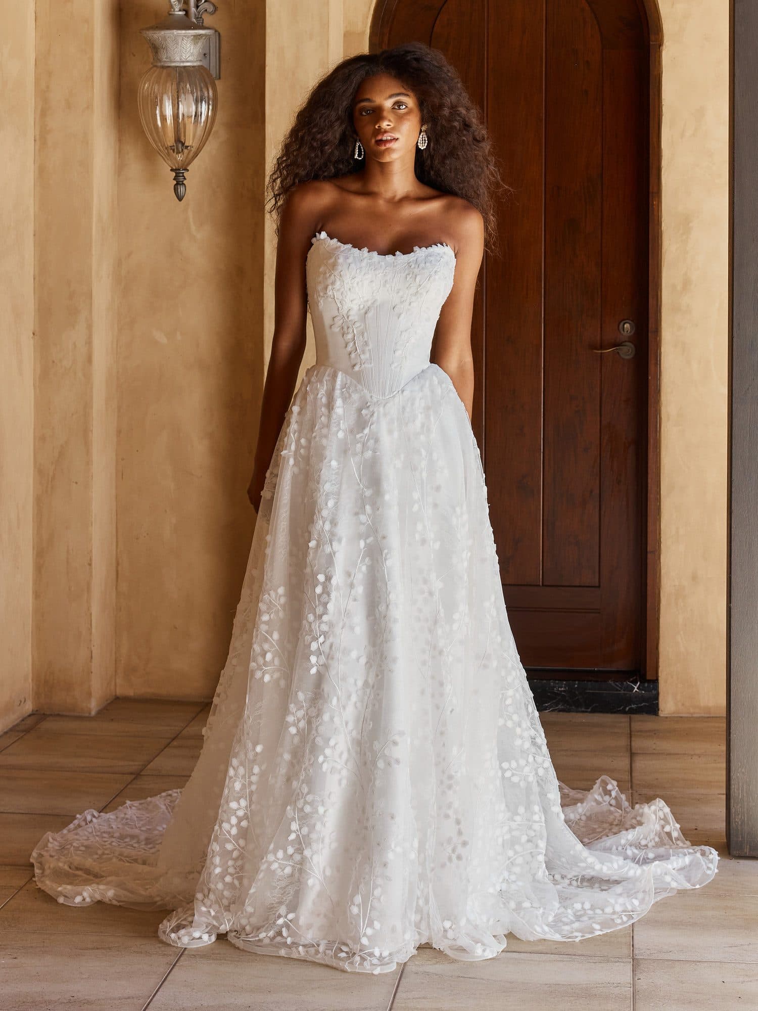 Front of the Madi Lane Oriel gown, a strapless A-line covered in three-dimensional floral lace.