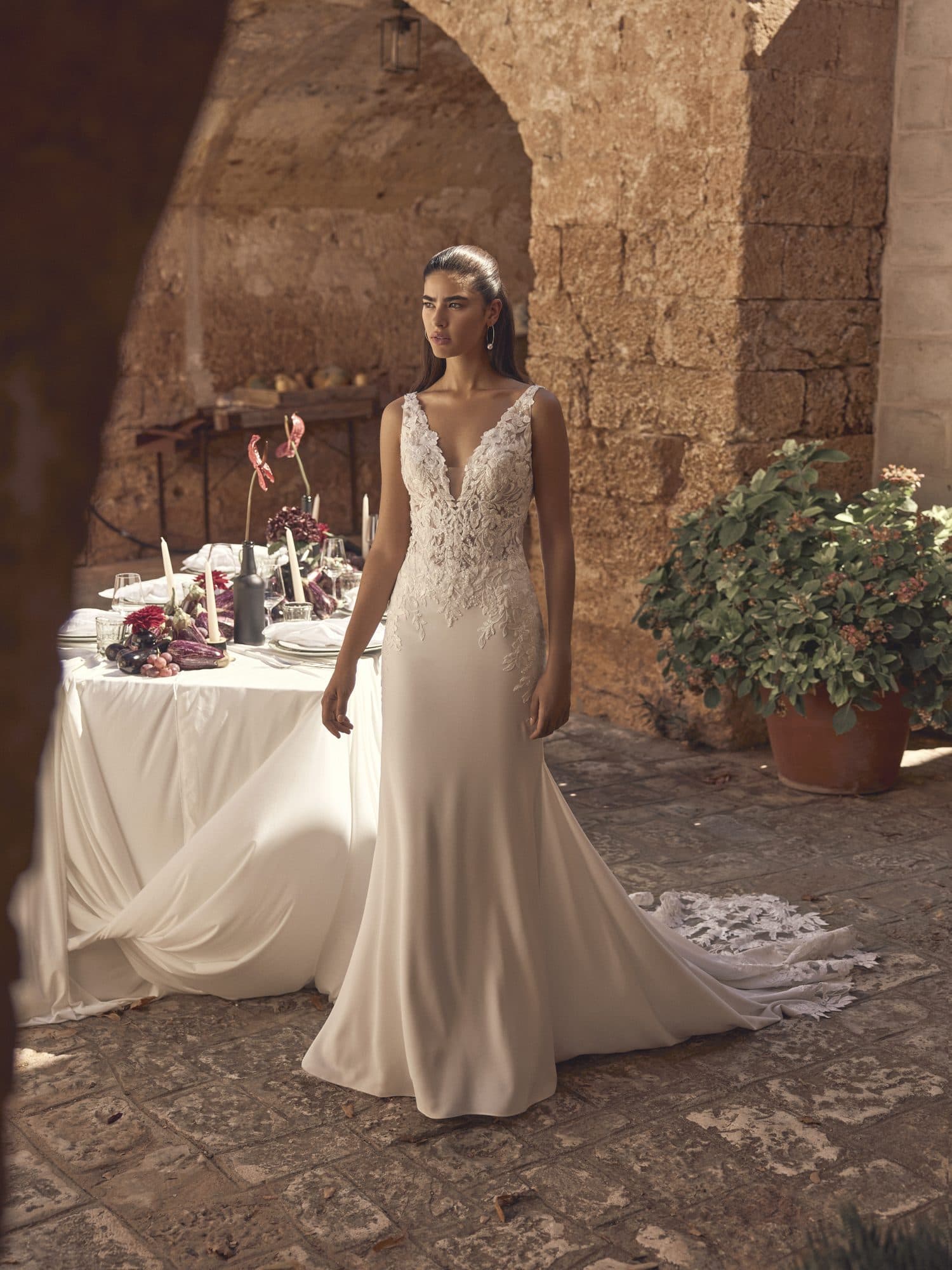 Front of the Modeca Mariette gown, a V-neck lace bodice over a fluid crepe skirt.