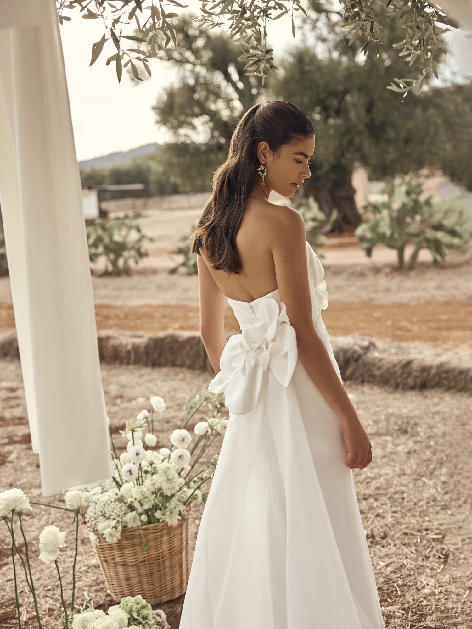 Back of the Modeca Mona gown showing its oversized bow above the train.